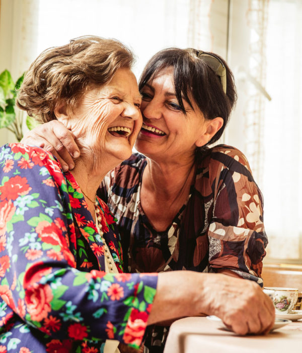 Two women laughing and smiling